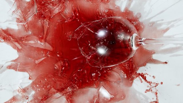 Super Slow Motion Top Shot of Breaking Glass with Red Wine on White Cloth at 1000fps.