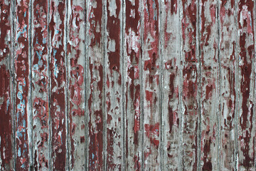 The damaged plank wall painted in red