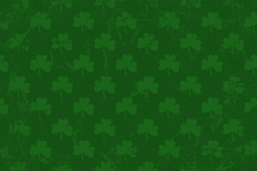 Grunge pattern with signs of shamrocks. Horisontal green shade backgrop.