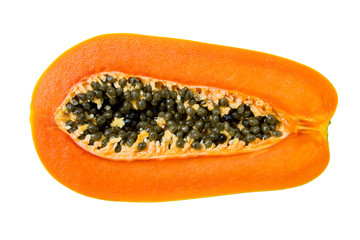 Half of ripe papaya fruit and seeds isolated on white background and clipping path. It is ripe when it feels soft and it's skin has attained an amber to orange hue.