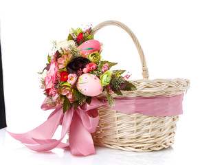 Decorative wicker basket with original floral decor and long colored ribbons.