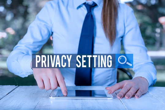 Writing note showing Privacy Setting. Business concept for limit the access of profile and what information can see Female business person sitting by table and holding mobile phone - Powered by Adobe