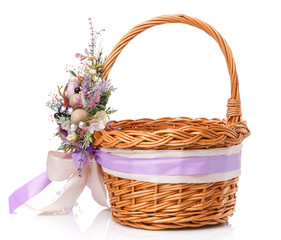 Fototapeta na wymiar Wicker basket decorated with flowers on white background