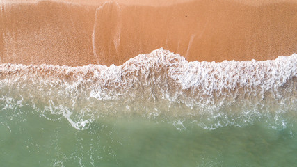 Fototapeta na wymiar Top down view landscape scene of waves crashing on empty tropical beach