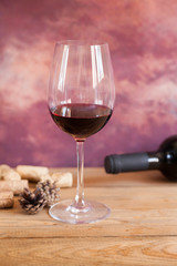 glass of red wine and corks