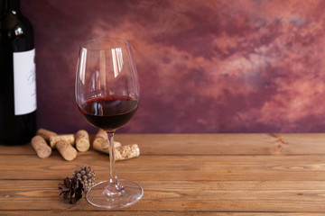 glass of red wine on wooden table