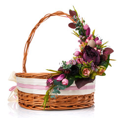 Fototapeta na wymiar Provence Easter floral arrangement on a wicker basket with a vine. Isolated