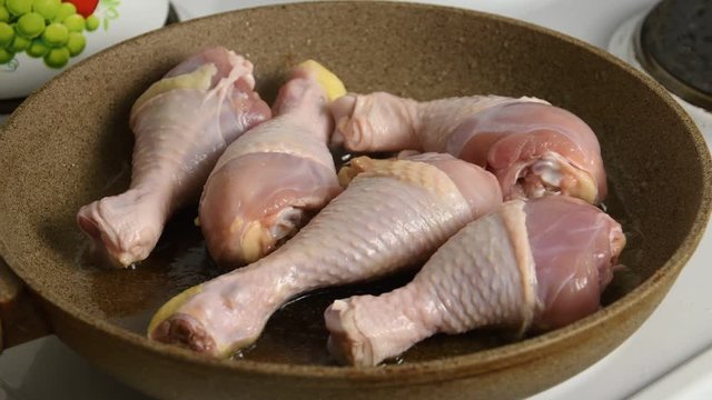 Raw Chicken Legs Frying In a Pan