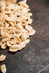 Salted peanuts on rustic background. Selective focus. Shallow depth of field.