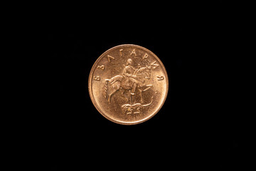 Bulgarian 5 stotinki coin from 2000, obverse showing The Madara Rider on his horse, killing a lion with a spear, isolated on black background