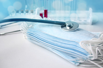 tinted photo of medical laboratory test tubes, stethoscope, disposable protective masks, concept of...