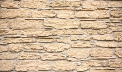 Texture of stone wall, square yellow travertine tile.