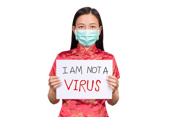 Asian woman in Chinese costume wear a hygienic mask holding sign I am not a VIRUS for anti racism ,...