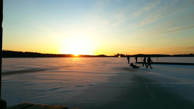 Golden sunset at snow covered lake, Sledge winter activity, Long shot