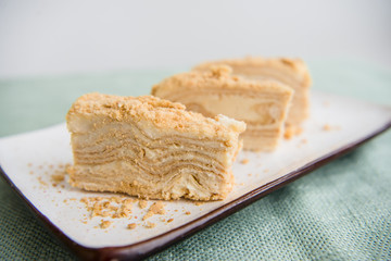 Piece of napoleon cake. Classic layered russian cake.  French mille feuille with whipped sour cream. 