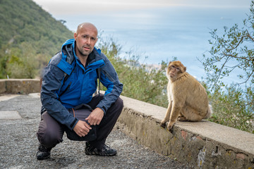 A tourist explores a monkey in the wild in Gibraltar