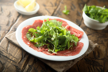 Beef carpaccio with fresh arugula salad