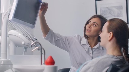 Doctor dentist analyzing teeth x-ray tommography medical data on touchscreen computer, work late at night, working with modern digital technologi in hospital concept. - Powered by Adobe
