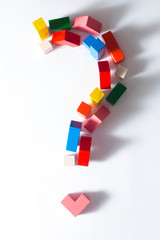 Question mark made from multi-colored cubes on a white background.