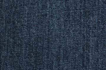 Old blue denim jeans texture or background with visible fibers