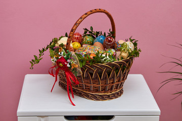 Fototapeta na wymiar Ukrainian Easter basket,decorated basket with Easter eggs and Easter cake, also horseradish with sausage and ham and butter with cheese