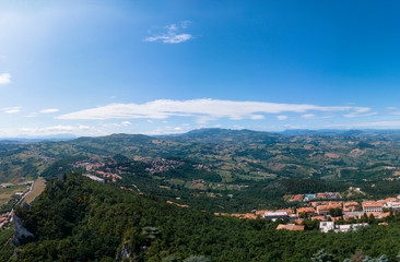 Fototapeta na wymiar Aerial view on Third, distant tower on top of the mountain. Fortifications, in the background mountains and the city. The concept of wide panorama wallpaper Europe. San Marino, Italy