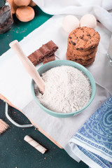 Pastry ingredients, eggs and flour with ready cookies