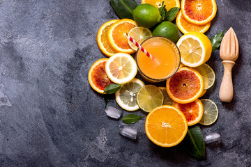 Citrus juice in glass and sliced citrus fruits, healthy drink