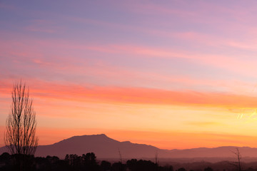 Colorful sunset with a mountain in the background. Basque Country.