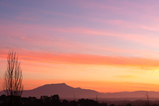 Colorful sunset with a mountain in the background. Basque Country.