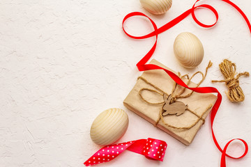 Zero waste Easter concept. Wooden eggs, gifts in craft paper. Not plastic, eco trend. White putty...