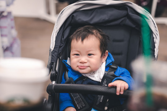 Asian little baby boy sitting in stroller
