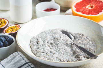 Cooking chia pudding with fruits, milk and muesli. Vegan breakfast concept.