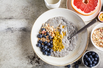 Chia pudding bowl with blueberries, passion fruit and granola, top view. Healthy breakfast concept.