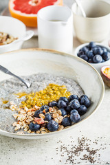 Chia pudding bowl with blueberries, passion fruit and granola. Healthy breakfast concept.