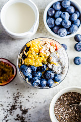 Chia pudding with blueberries, passion fruit and granola in glass, top view. Healthy breakfast concept.