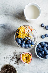 Chia pudding with blueberries, passion fruit and granola in glass, top view. Healthy breakfast concept.