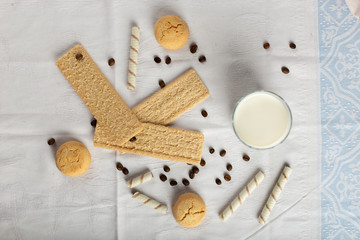 Cracker bread and cookies with a glass of milk