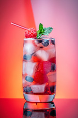 mojito, berry and cola cocktails with lime and ice on color background