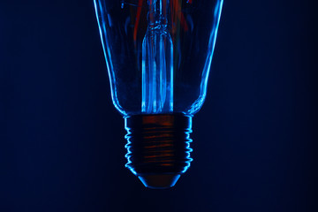 Light bulb on black background close up