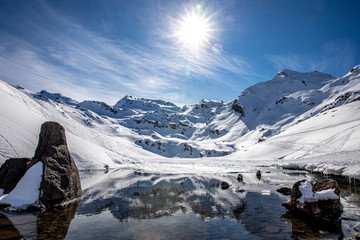 Saint-Martin-de-Belleville, France - February 21, 2020: The snow-covered mountain and its reflection in Lac du Lou near Val Thorens resort