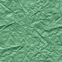 Crumpled paper background in admirable green color for stylish holiday gift. Seamless texture.
