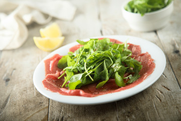 Beef carpaccio with fresh arugula salad