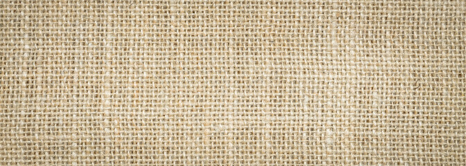 Rough hessian background with flecks of varying colors of beige and brown. with copy space. office desk concept, Hessian sackcloth burlap woven texture background.