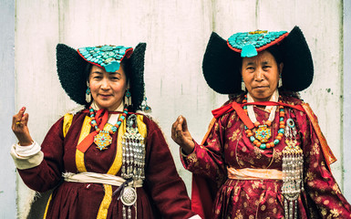 Portrait of women in traditional tibetan clothes inside their house in Ladakh, Kashmir, India - 325677081