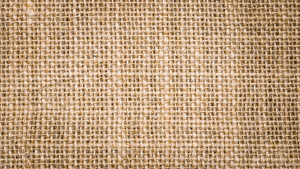 Rough hessian background with flecks of varying colors of beige and brown. with copy space. office desk concept, Hessian sackcloth burlap woven texture background.