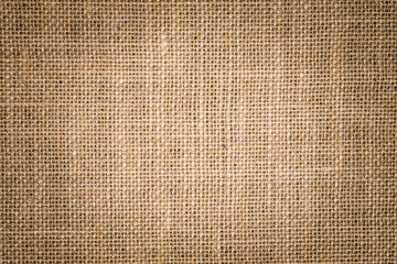 Rough hessian background with flecks of varying colors of beige and brown. with copy space. office desk concept, Hessian sackcloth burlap woven texture background.