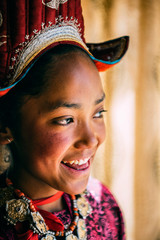 Portrait of a beautiful young girl in typical tibetan clothes with hat in Ladakh, Kashmir, India - 325677871