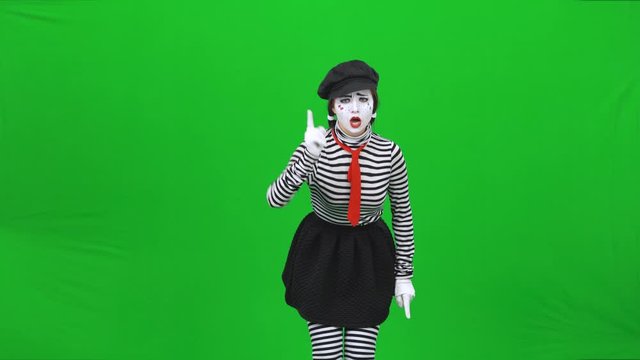 Mime girl is scolding someone and showing fist. Chroma key.