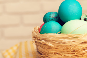 Easter decorative nest with colored eggs close up